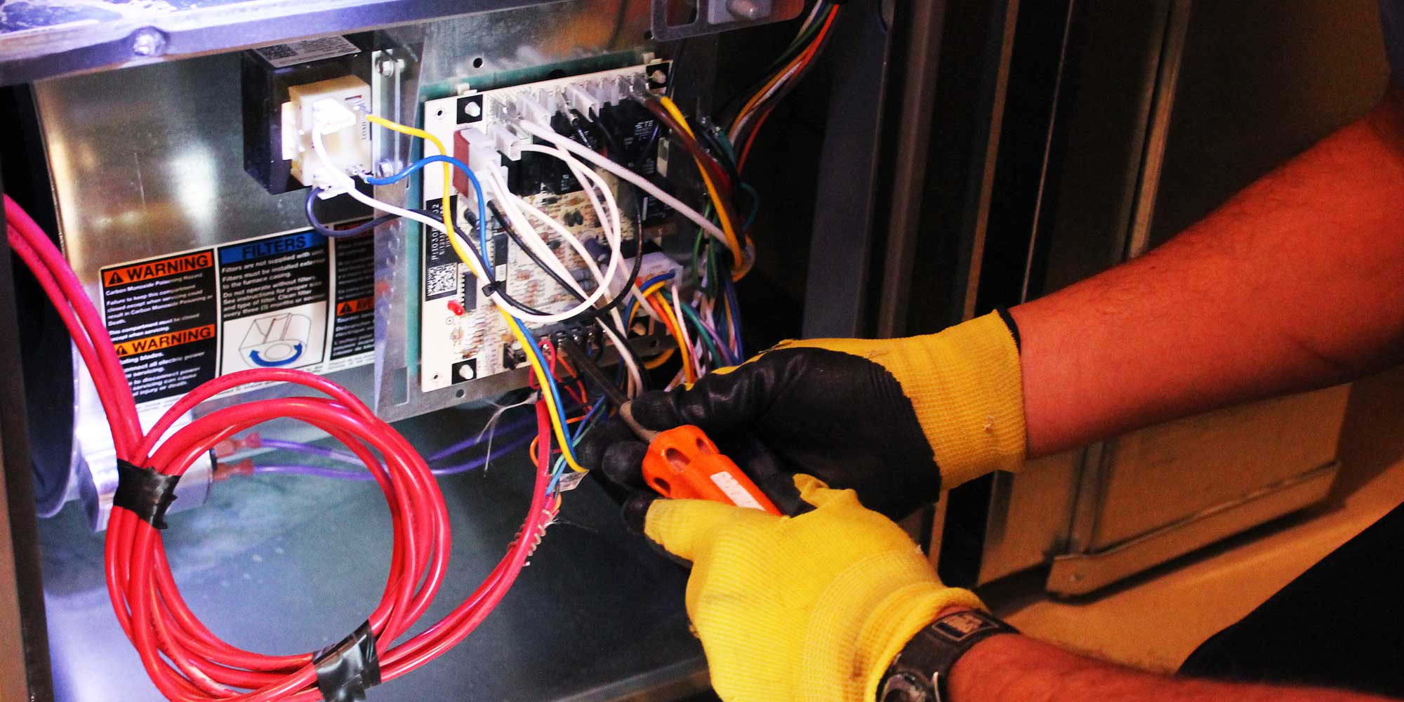 Technician repairing a furnace in Calgary