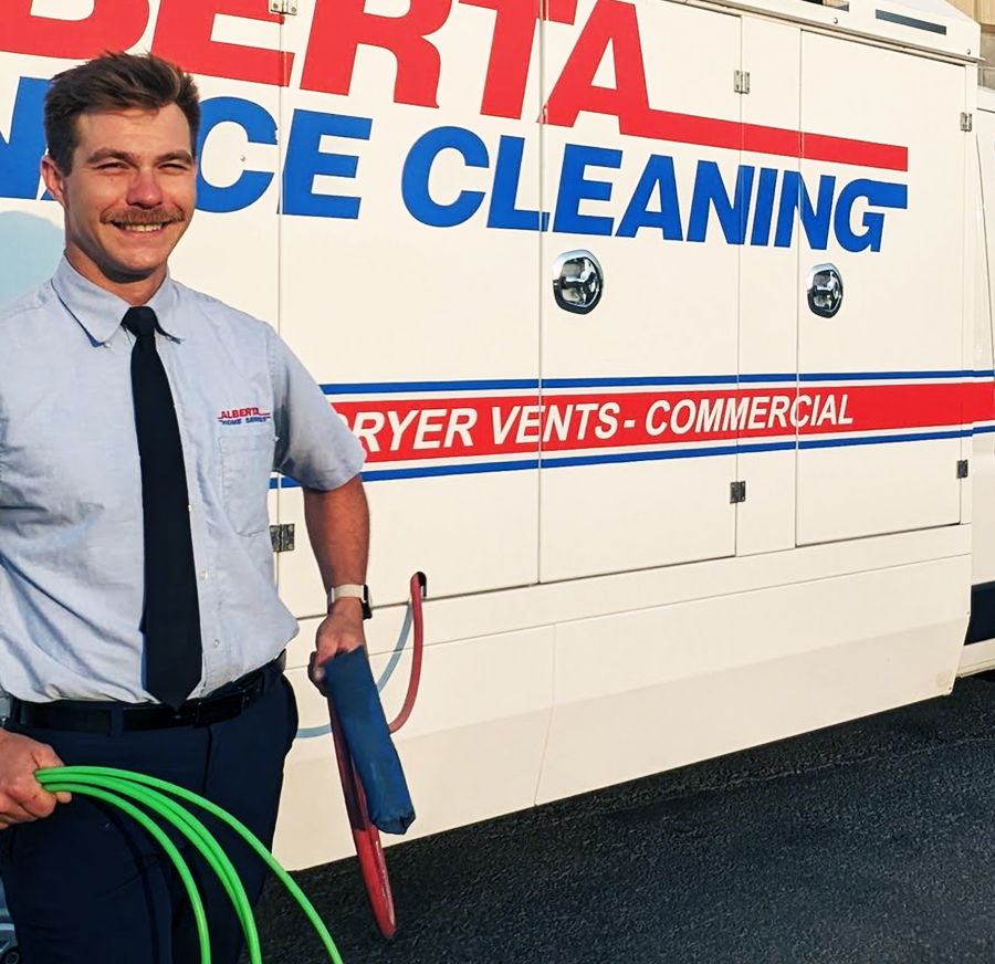 Alberta Furnace Cleaning Technician holding a duct cleaning hose
