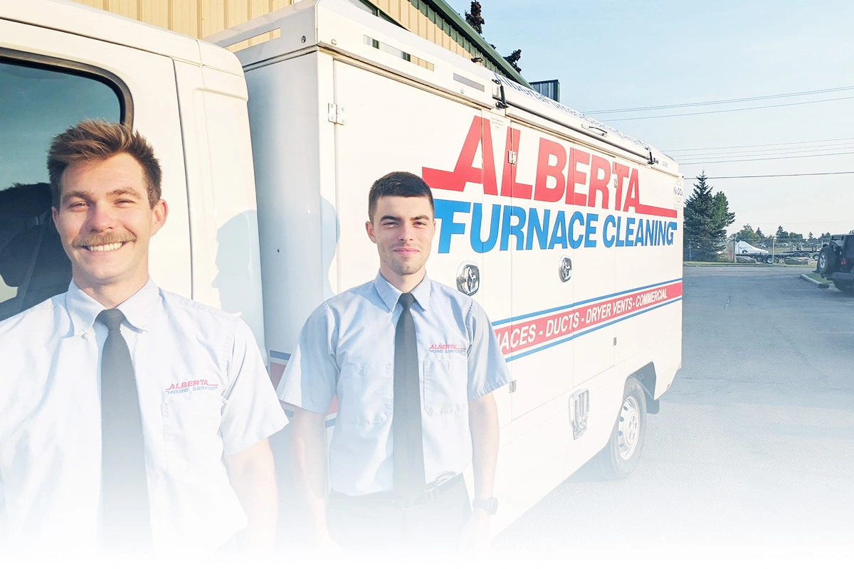 Alberta Furnace Cleaning Technicians standing in front of a furnace and duct cleaning truck
