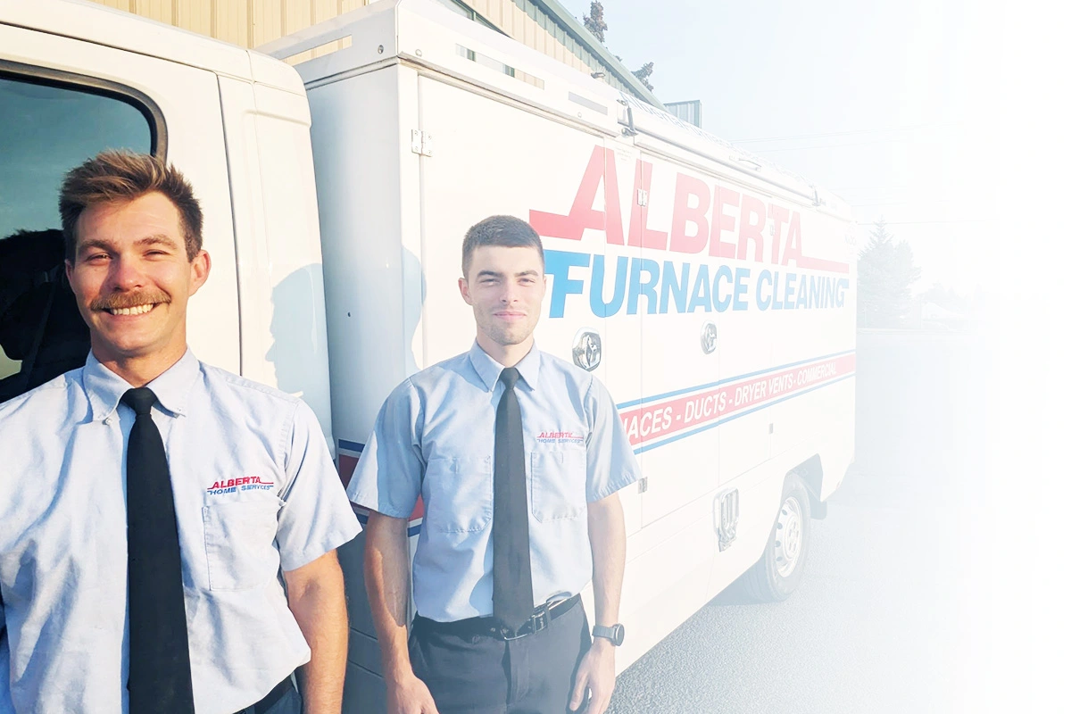 Alberta Furnace Cleaning Technicians standing in front of a furnace and duct cleaning truck